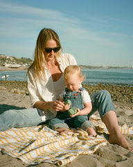 Mother and baby on the beach with Cadence Capsules - main-only